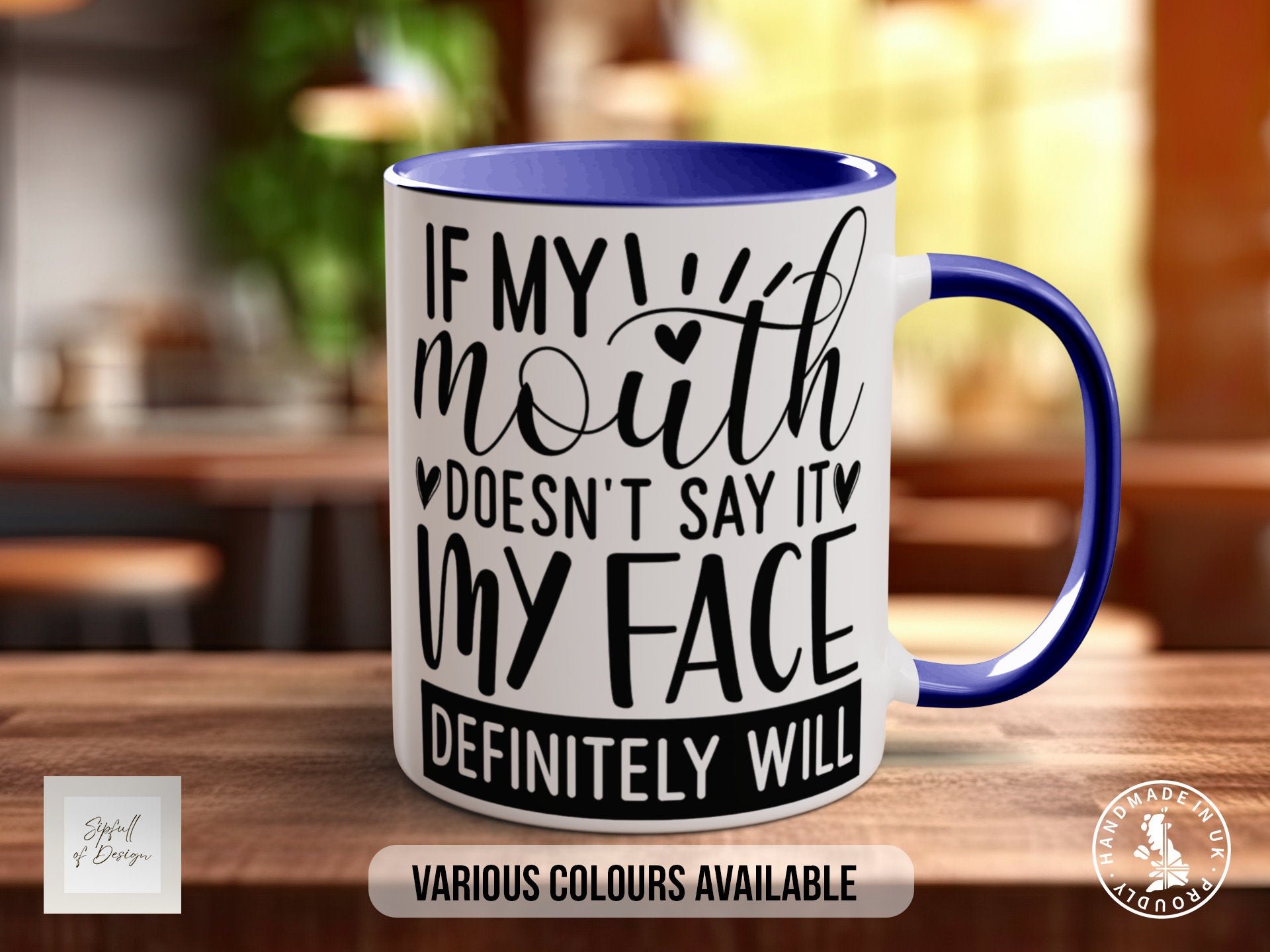 a blue and white coffee mug sitting on top of a wooden table